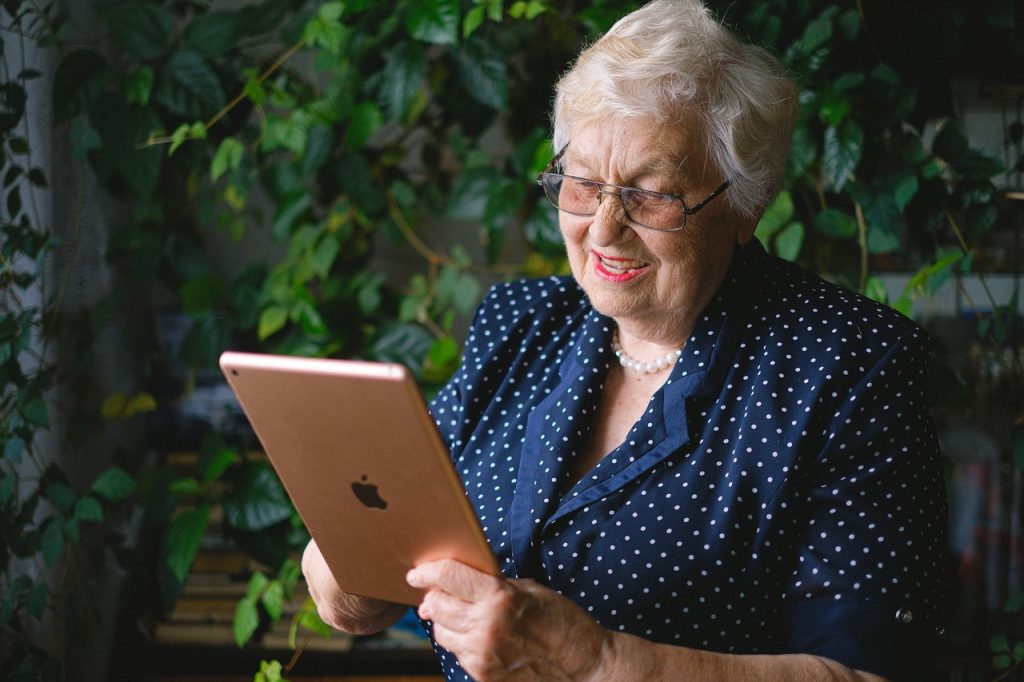 A lady wishing goodbye to a loved one on a tablet