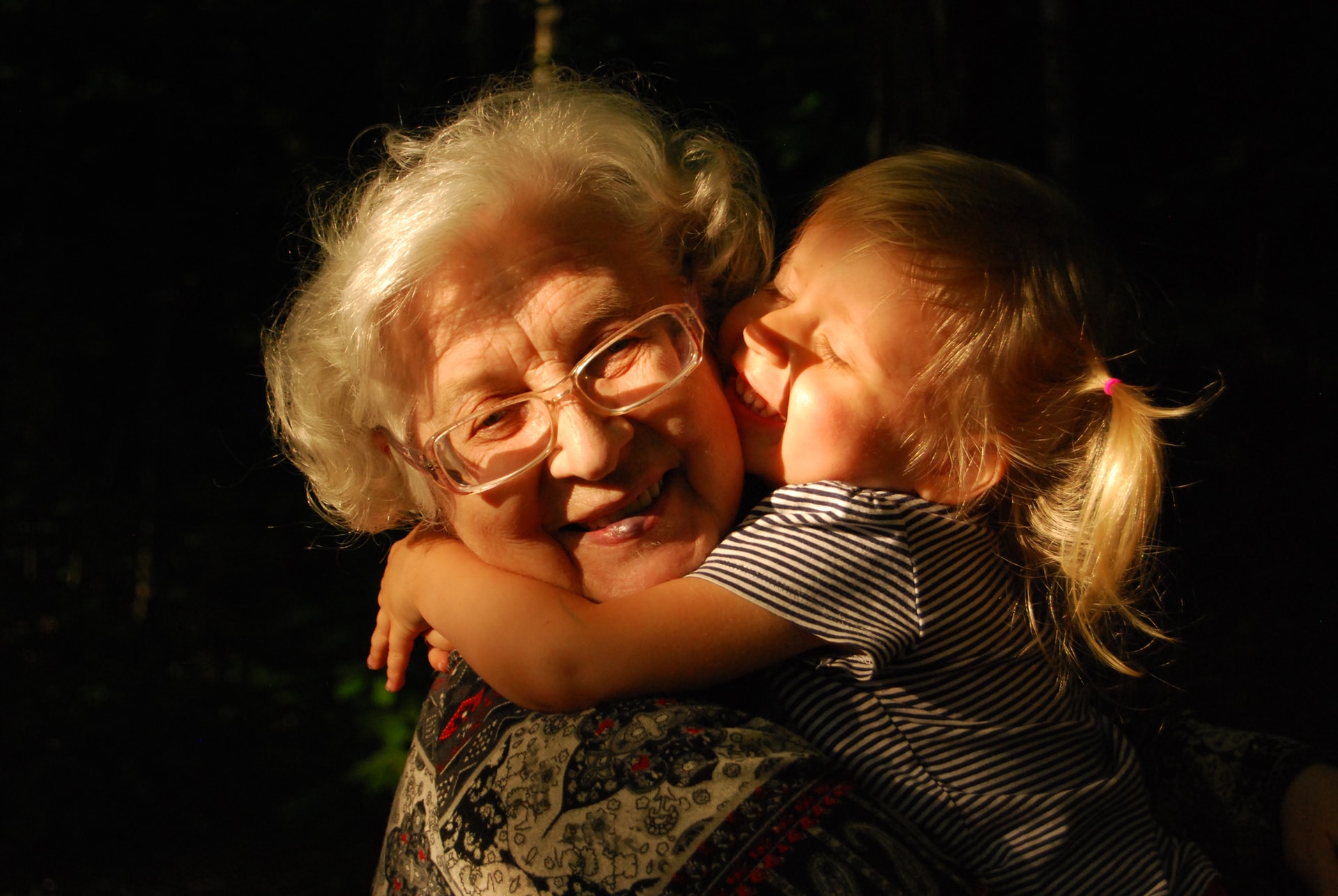 Grandmother hugging her grand daughter